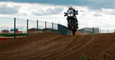 a person riding a motorcycle on a dirt road