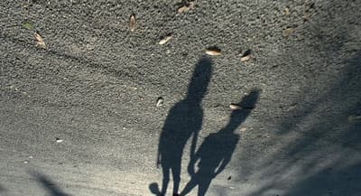 a shadow of a person standing in the sand