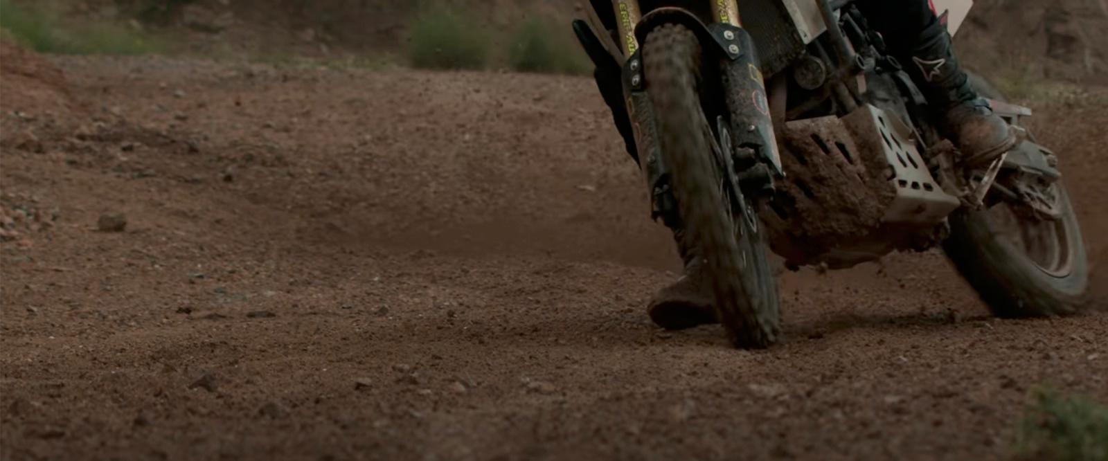 a person riding a dirt bike on a dirt road