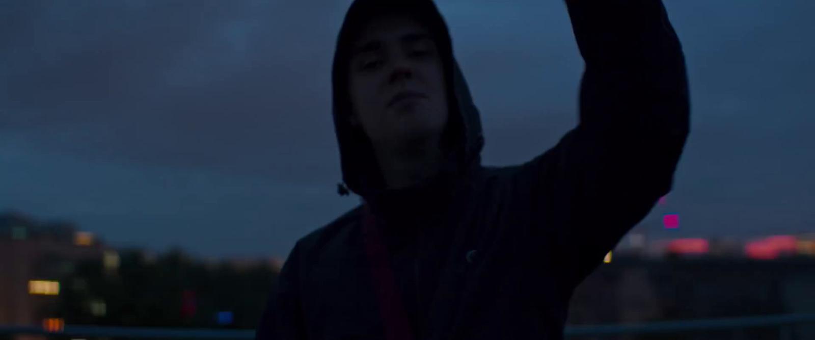 a man holding a cell phone up in the air