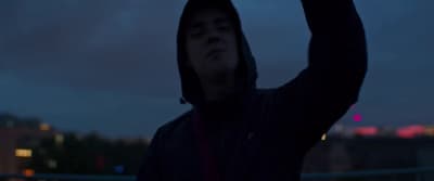 a man holding a cell phone up in the air