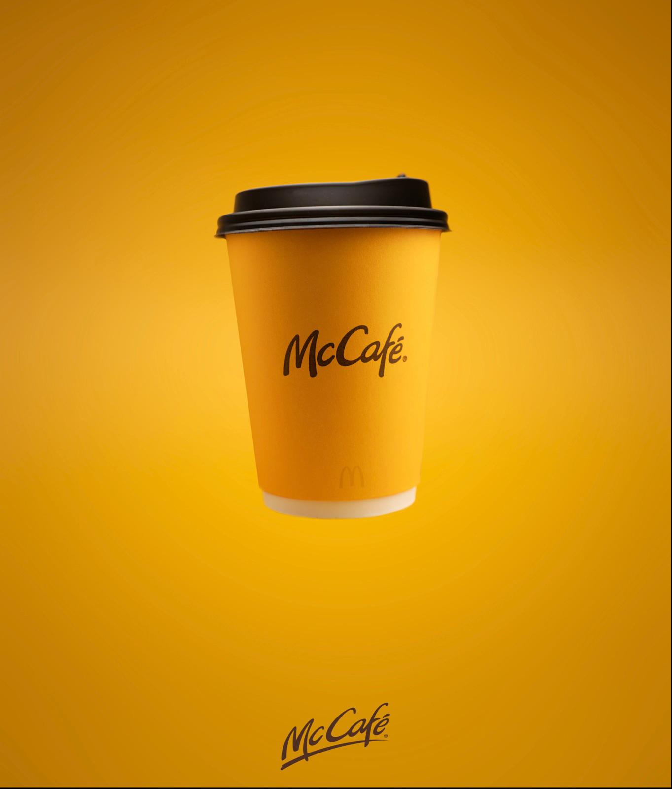 a cup of coffee with a black lid