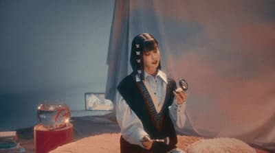 a man dressed in a pirate costume holding a magnifying glass