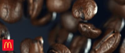 a mcdonald's logo is surrounded by coffee beans