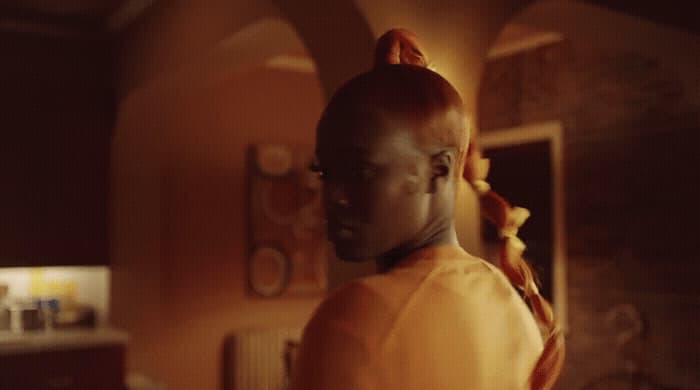 a woman with red hair wearing a yellow shirt