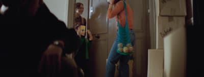 a man standing in front of a mirror holding a cell phone to his ear