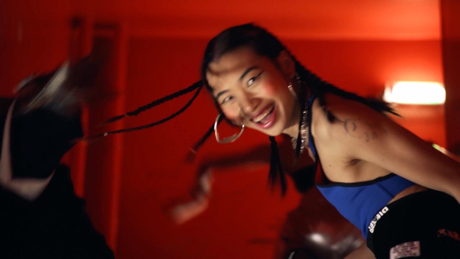 a woman with dreadlocks and a blue shirt