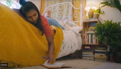 a woman laying on a bed with a yellow blanket