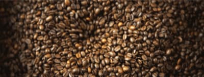 a large pile of coffee beans sitting on top of a table
