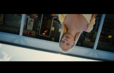 a woman is upside down in front of a store