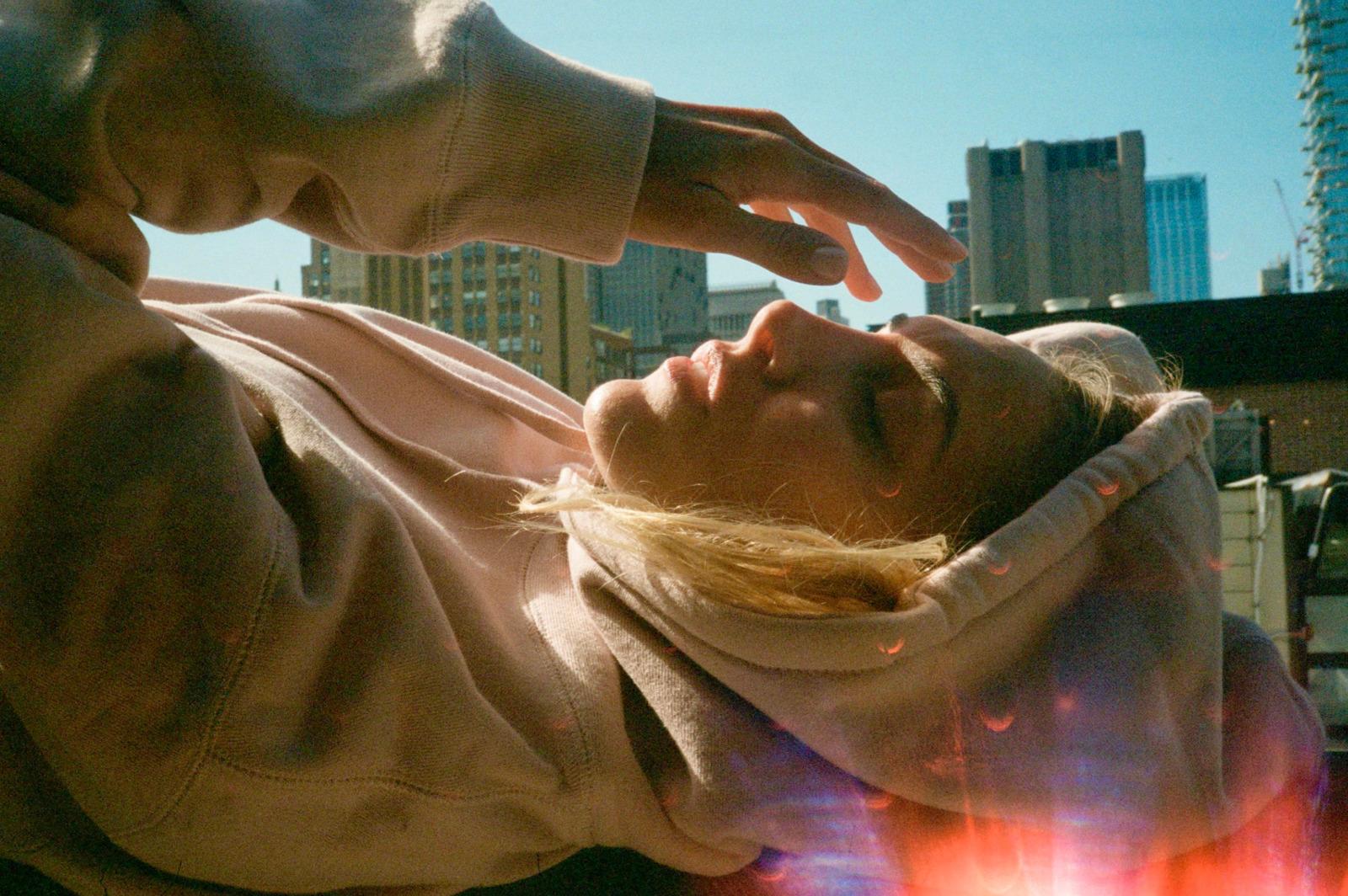 a woman laying on her back with her eyes closed