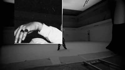 a black and white photo of a person standing in a room