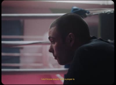 a man in a boxing ring looking at something
