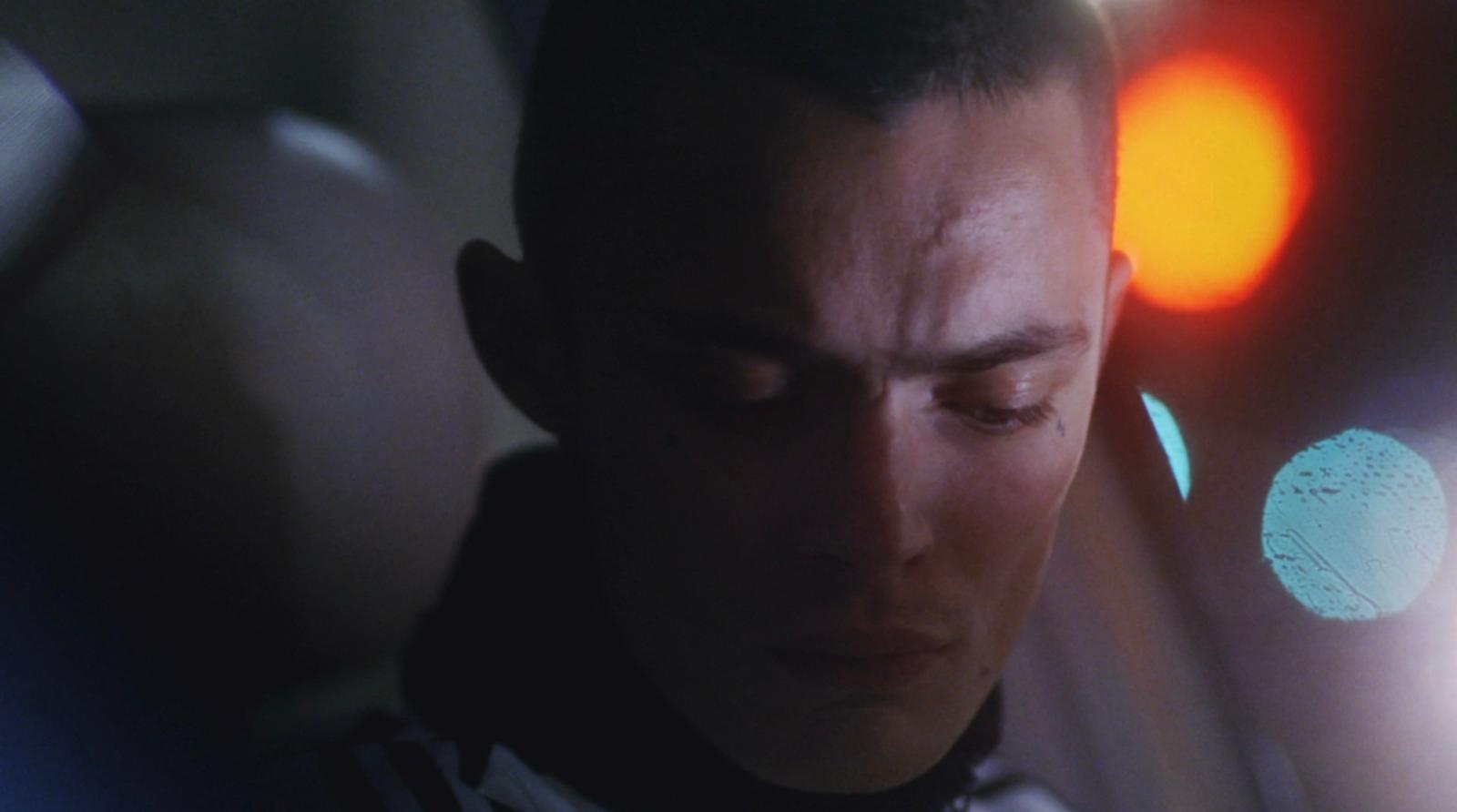 a man with his eyes closed looking at his cell phone