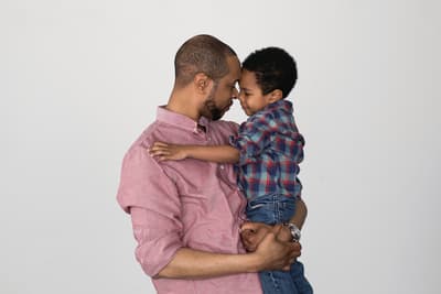 a man holding a small child in his arms