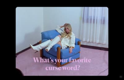 a woman sitting on a blue chair in a room