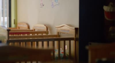 a baby's room with a crib and a window