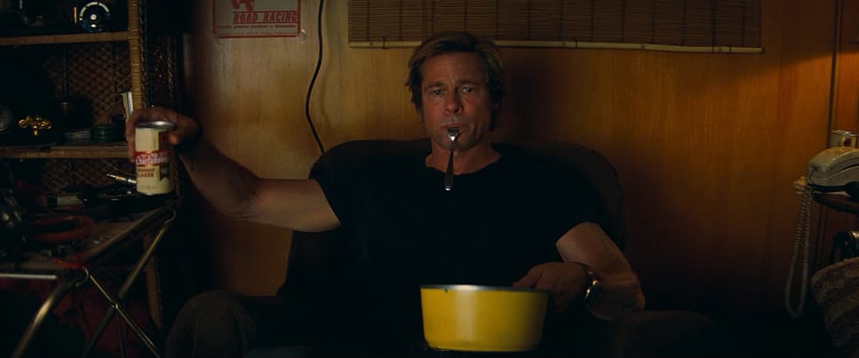 a man sitting in a chair with a drink in his mouth