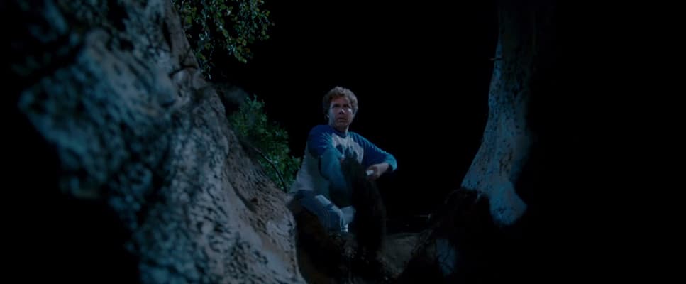 a man sitting on a rock in the dark