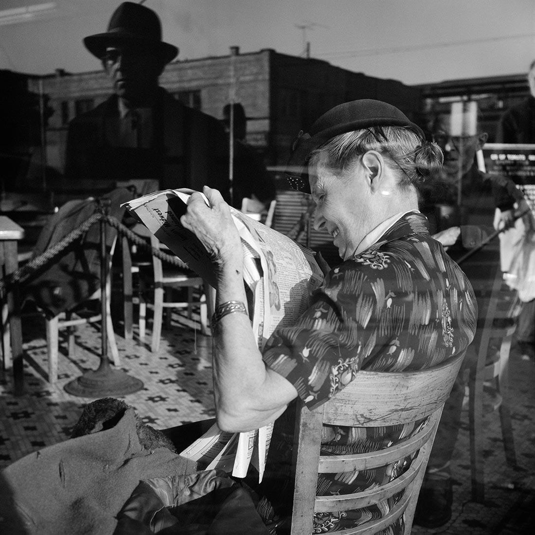 a black and white photo of a man sitting in a chair