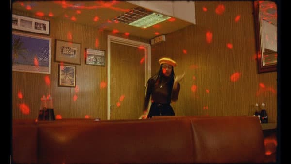 a woman standing in front of a mirror in a room