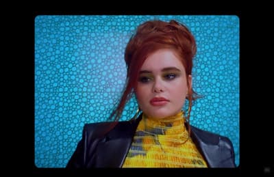 a woman with red hair wearing a black leather jacket