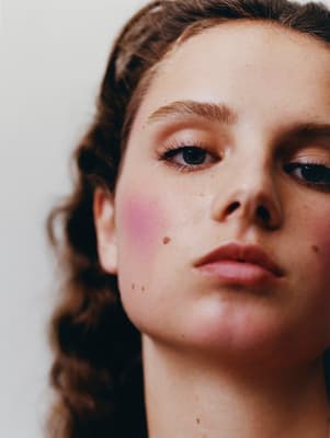 a close up of a woman's face with makeup on