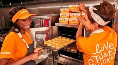 a couple of women that are in a kitchen