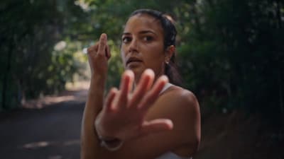 a woman holding her hand up in the air