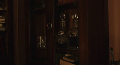 a wooden cabinet with glass doors in a room