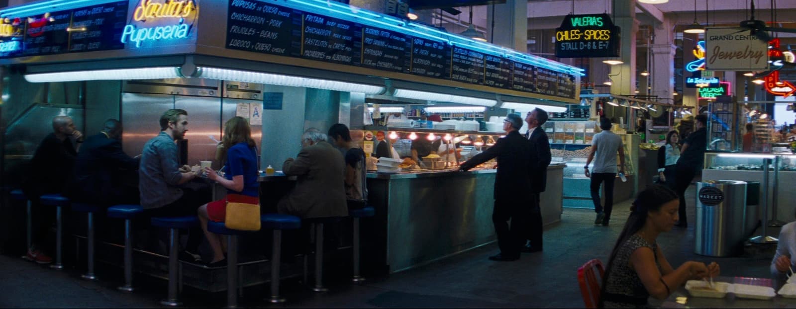 a group of people standing around a restaurant