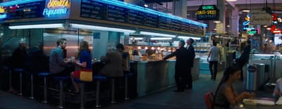 a group of people standing around a restaurant