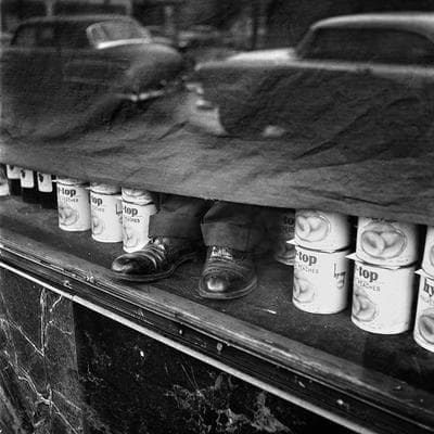 a black and white photo of a shelf with cups
