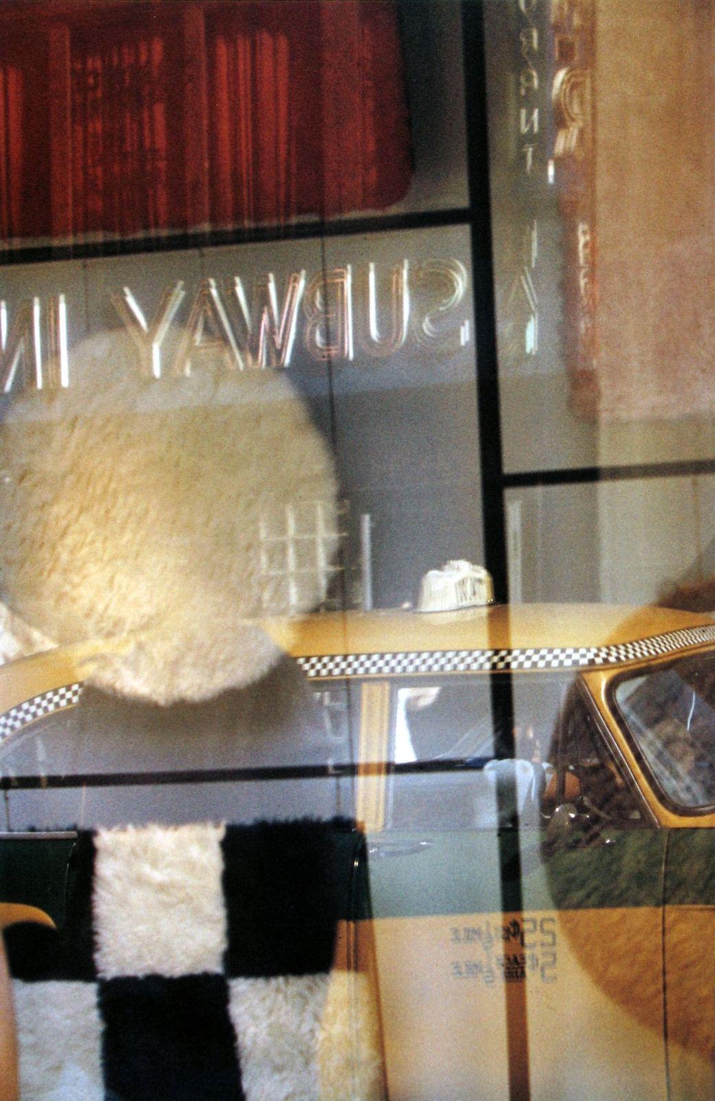 a window display with a teddy bear and other items