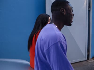 a man and a woman standing in front of a door