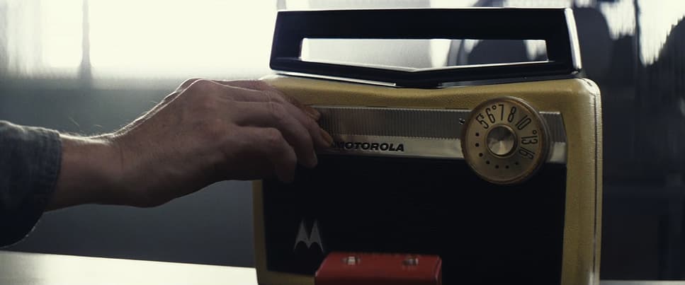 a person is putting a radio on a table