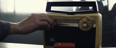 a person is putting a radio on a table