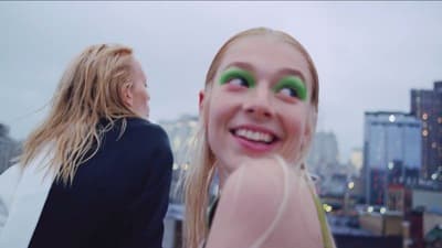 a woman with green eyes standing next to another woman