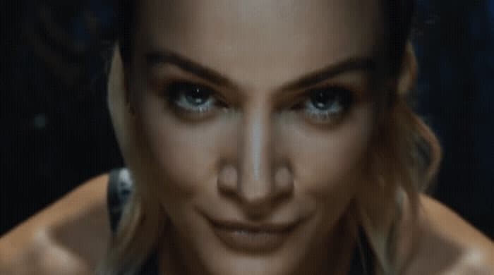 a close up of a woman's face with blue eyes