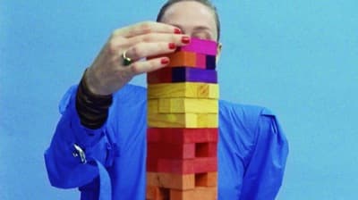 a woman holding a colorful object in her hands