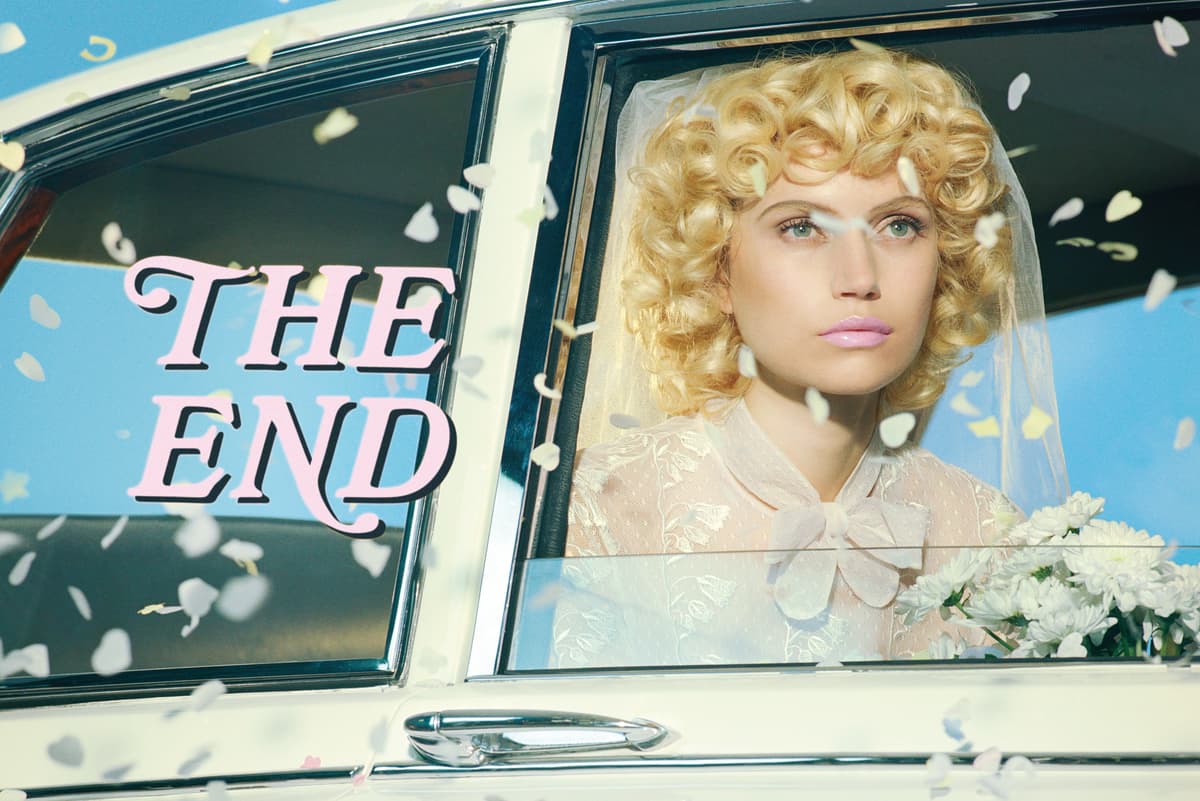 a woman with blonde hair sitting in a car