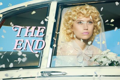 a woman with blonde hair sitting in a car