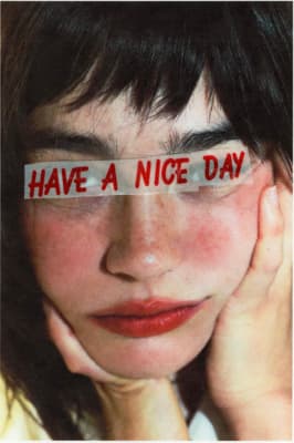a woman holding a piece of paper with the words have a nice day on it