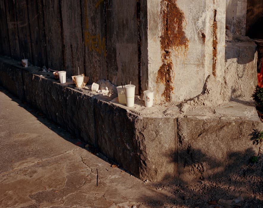 a bunch of cups that are sitting on a ledge