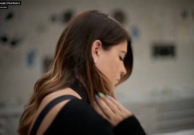 a woman in a black top is looking at her cell phone