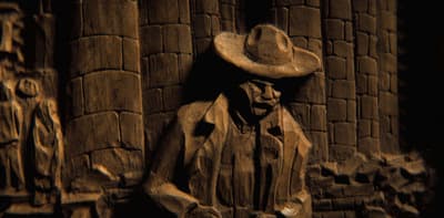 a statue of a man wearing a cowboy hat