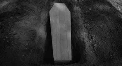 a wooden bench sitting in the middle of a dirt field