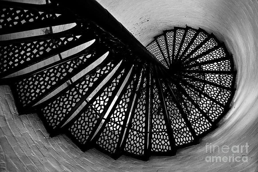 a black and white photo of a spiral staircase