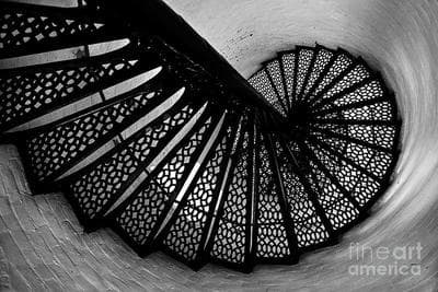 a black and white photo of a spiral staircase