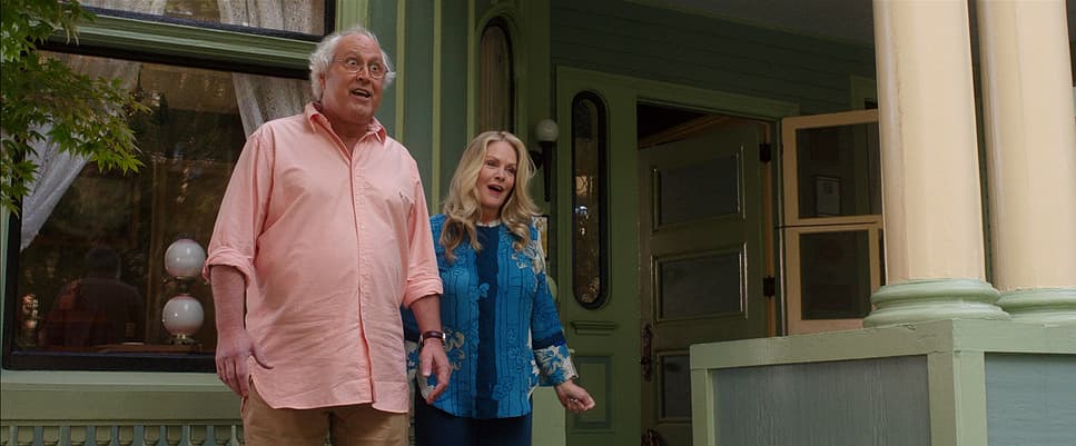 a man and a woman standing outside of a house